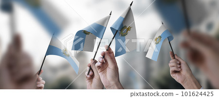 A group of people holding small flags of the San Marino in their hands A group of people holding small flags of the San Marino in their hands 101624425