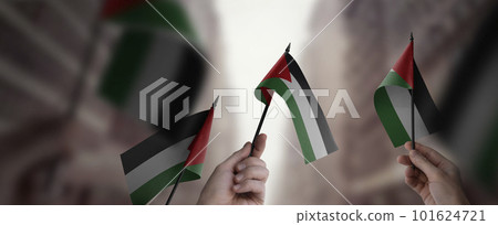 A group of people holding small flags of the Palestine in their hands 101624721