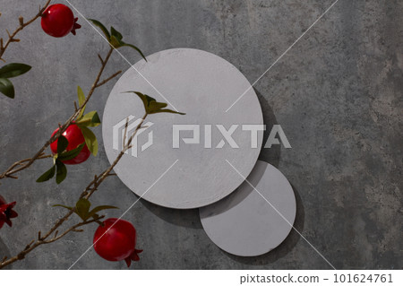 top view of white circle, green leaves and red pomegranate, backdrop illustration for advertising. 101624761