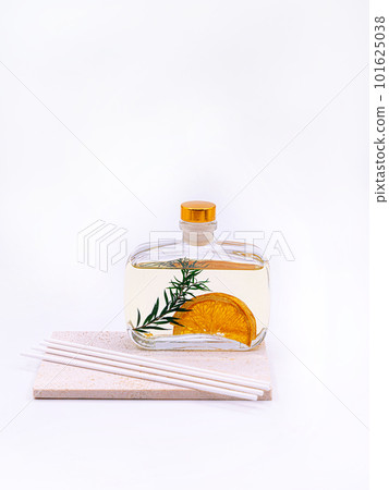 Reed diffuser with cinnamon and orange on white background Reed diffuser with cinnamon and orange on white background 101625038