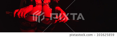 ass slave girl with hands in leather handcuffs and whip Flogger for BDSM sex 101625859
