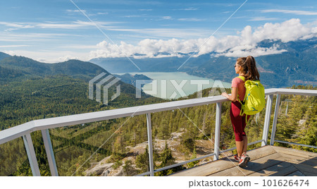 Woman hiking standing at view point Stawamus Chief Hike. Canada Tourism, British Columbia. Hiking tourist in breathtaking nature landscape during hike onwalk in outdoor paradise Squamish, BC, Canada Woman hiking standing at view point Stawamus Chief Hike. Canada Tourism, British Columbia. Hiking tourist in breathtaking nature landscape during hike onwalk in outdoor paradise Squamish, BC, Canada 101626474