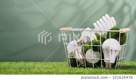 Earth Day. Assorted led bulbs in basket in green background. Environment day. Safe disposal, ecology concept. Renewable energy efficient technologies. Climate change and ethical consumerism 101626476