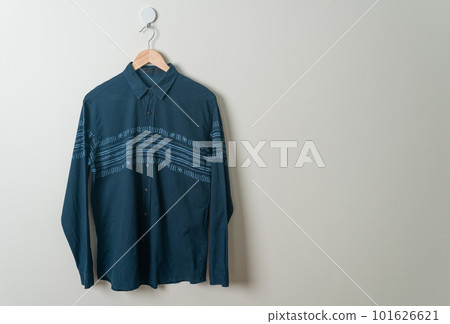 hanging shirt with wood hanger on wall 101626621