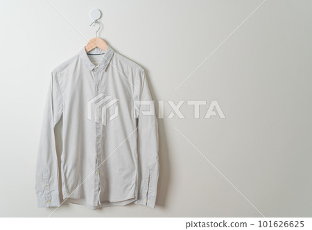 hanging shirt with wood hanger on wall 101626625