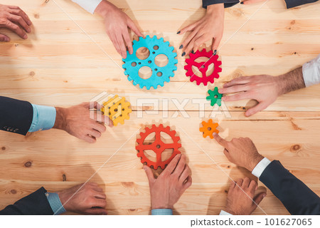 Business team connect pieces of gears like a teamwork and partners 101627065