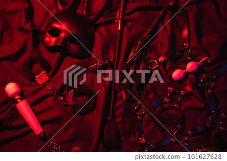 Vibrator, whip, handcuffs and mask for BDSM sex with submission and domination. Set of adult erotic sex toys 101627628