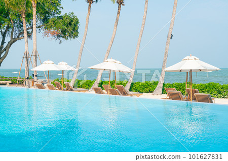 umbrella with bed pool around swimming pool with ocean sea background 101627831