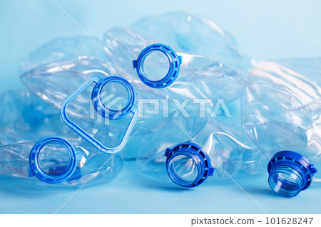 a lot of plastic empty rumpled used bottles on a blue background. waste and pollution concept 101628247