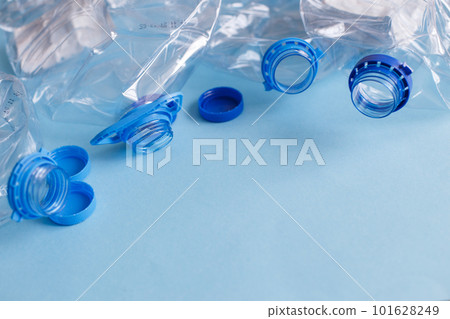 a lot of plastic empty rumpled used bottles on a blue background. waste and pollution concept 101628249