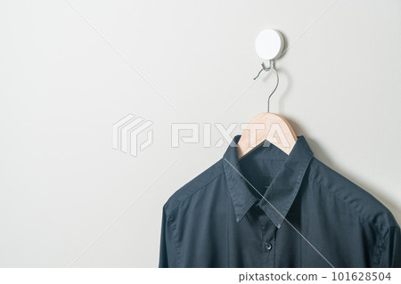 hanging shirt with wood hanger on wall 101628504