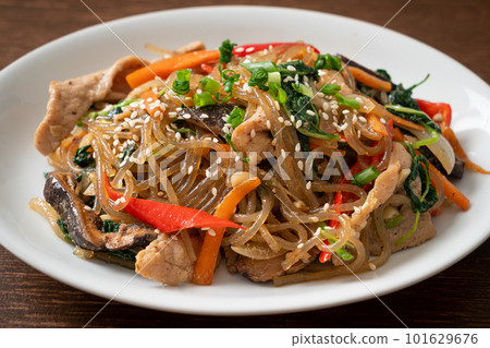 japchae or stir-fried Korean vermicelli noodles with vegetables and pork topped with white sesame 101629676