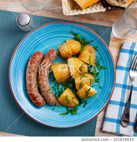 Grilled homemade sausages served with boiled potato Grilled homemade sausages served with boiled potato 101630034