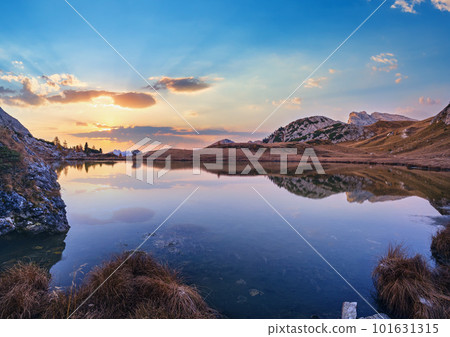 Early morning autumn alpine Dolomites mountain scene. Peaceful Valparola Path and Lake view, Belluno, Italy. 101631315