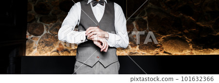 Groom in suit and bowtie correct watch. 101632366