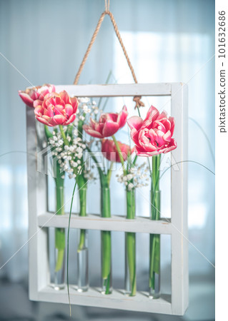 hanging composition with tulips in test tubes, flower flasks 101632686