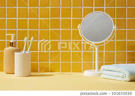 A mirror, towel and toothbrushes inside a bathroom background. Front view. Empty space for display cosmetic products 101633030