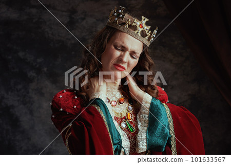 stressed medieval queen in red dress having neck pain 101633567