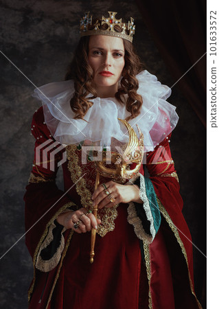 medieval queen in red dress with venetian mask 101633572