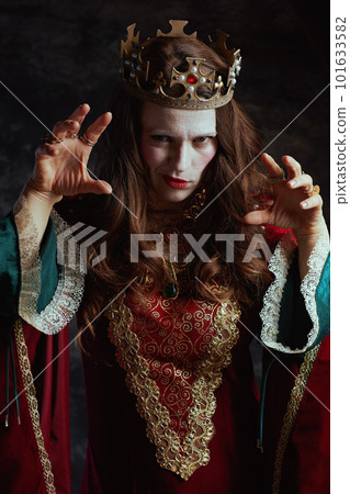 scary medieval queen in red dress with white makeup and crown scary medieval queen in red dress with white makeup and crown 101633582