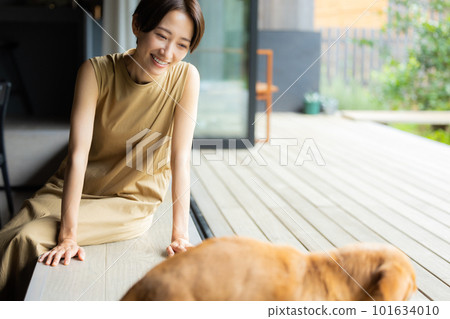 A woman holding a dog 101634010