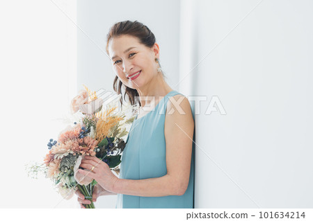 Smiling middle-aged woman doing skin care Smiling middle-aged woman doing skin care 101634214
