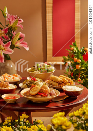 A wooden table full of Vietnamese traditional dishes commonly encountered on Tet holiday. Front view 101634364