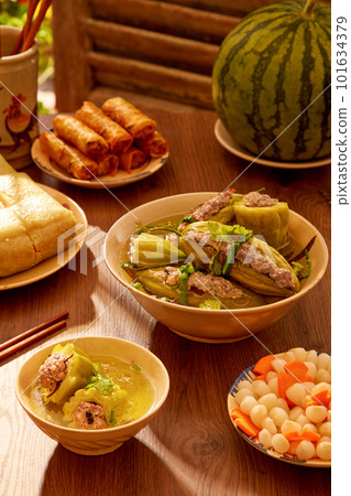 A bowl of pork stuffed bitter melon soup, a dish of pickled small leeks watermelon and watermelon. Tet holiday concept 101634379
