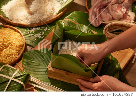 Vietnamese traditional Chung cake with dong leaves, pork glutinous rice for holiday food advertising. Traditional lunar new year food Vietnamese traditional Chung cake with dong leaves, pork glutinous rice for holiday food advertising. Traditional lunar new year food 101634597