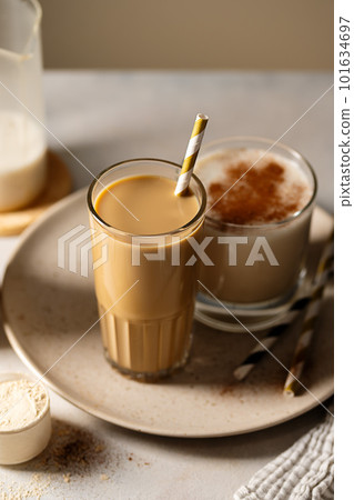 Glass of protein chocolate drink milkshake or coffee refreshing drink, moody lifestyle photo 101634697