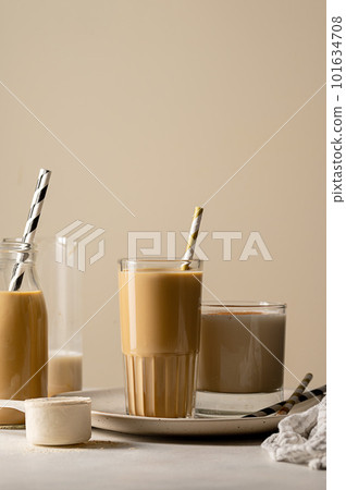 Glass of protein chocolate drink milkshake or coffee refreshing drink, moody lifestyle photo 101634708