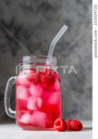 Raspberry refreshing lemonade in mason jar with glass straw, summer cold drink. 101634720