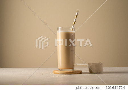 Protein powder and drink in a glass. Copy space. 101634724
