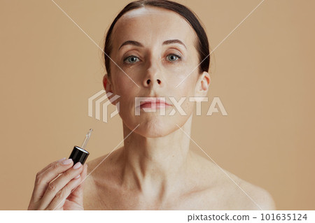 modern 40 years old woman against beige background 101635124