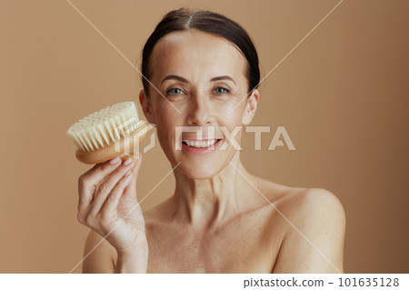 smiling modern 40 years old woman isolated on beige background smiling modern 40 years old woman isolated on beige background 101635128