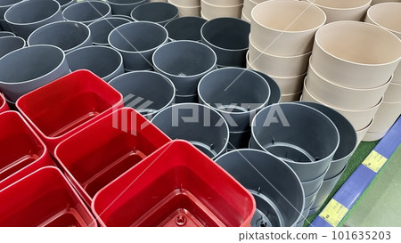 Close-up of empty flower pots in a store or greenhouse. Colorful pots for plants. Gardening and landscape design concept Close-up of empty flower pots in a store or greenhouse. Colorful pots for plants. Gardening and landscape design concept 101635203