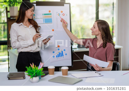 Concept of business office woman working,Businesswoman smile while working about her invesment plan with analyzing document and business investment graph data by using laptop on desk in workstation. Concept of business office woman working,Businesswoman smile while working about her invesment plan with analyzing document and business investment graph data by using laptop on desk in workstation. 101635281