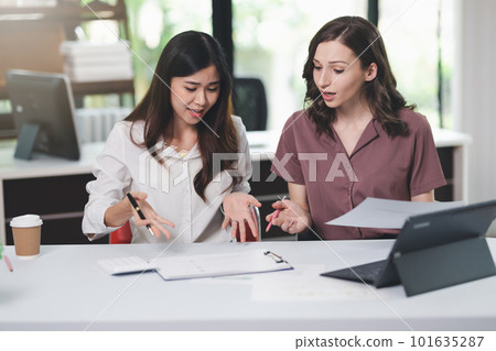 Concept of business office woman working,Businesswoman smile while working about her invesment plan with analyzing document and business investment graph data by using laptop on desk in workstation. Concept of business office woman working,Businesswoman smile while working about her invesment plan with analyzing document and business investment graph data by using laptop on desk in workstation. 101635287
