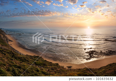 Evening summer ocean view over Carriagem beach at low tide (Aljezur, Algarve, Portugal). Evening summer ocean view over Carriagem beach at low tide (Aljezur, Algarve, Portugal). 101635632