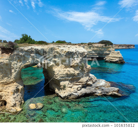 Picturesque seascape with cliffs, rocky arch and stacks (faraglioni), at Torre Sant Andrea, Salento sea coast, Puglia, Italy Picturesque seascape with cliffs, rocky arch and stacks (faraglioni), at Torre Sant Andrea, Salento sea coast, Puglia, Italy 101635812