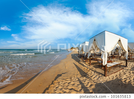 Beach tents canopies on morning paradise white sandy sea beach, Apulia, Italy. 101635813