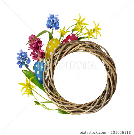 Wooden painted eggs and spring flowers with a twisted round nest frame and card for text isolated on white. Easter template. 101636118