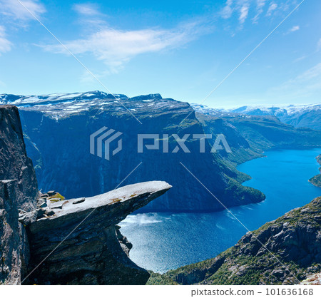The summer view of Trolltunga (The Troll's tongue) in Odda ( Ringedalsvatnet lake, Norway) and man on rocks edge. The summer view of Trolltunga (The Troll's tongue) in Odda ( Ringedalsvatnet lake, Norway) and man on rocks edge. 101636168