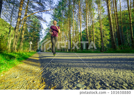 Man jogging in city partk at beautiful summer day. Sport fitness model caucasian ethnicity training outdoor. Man jogging in city partk at beautiful summer day. Sport fitness model caucasian ethnicity training outdoor. 101638880