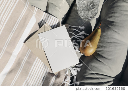 Summer vacation still life. Closeup of blank greeting card, invitation mockup. Beige striped beach towel. Sun bed composition with fresh pear fruit in sunlight, long shadows. Elegant stationery. Top Summer vacation still life. Closeup of blank greeting card, invitation mockup. Beige striped beach towel. Sun bed composition with fresh pear fruit in sunlight, long shadows. Elegant stationery. Top 101639168