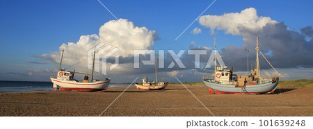 Summer clouds over fishing boats at the Slettestrand, Denmark. Summer clouds over fishing boats at the Slettestrand, Denmark. 101639248
