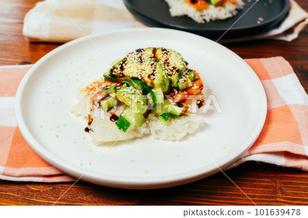 Sushi waffle is a cooking process. Culinary trend made with crispy rice waffles and sprinkled with salmon, cucumber and avocado. Sushi waffle is a cooking process. Culinary trend made with crispy rice waffles and sprinkled with salmon, cucumber and avocado. 101639478