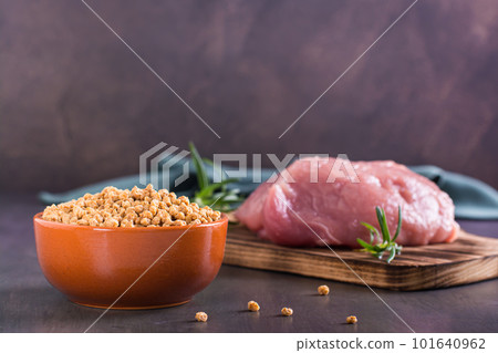 Choice between a bowl of soy meat and raw meat on the table Choice between a bowl of soy meat and raw meat on the table 101640962