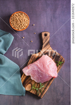 A piece of fresh meat on a cutting board and soy mince in a bowl top and vertical view A piece of fresh meat on a cutting board and soy mince in a bowl top and vertical view 101640972