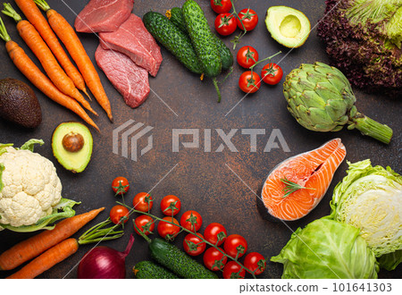 Various food raw products: vegetables, beef meat steak, fish salmon fillet on dark rustic brown stone table top view copy space. Healthy food background, ingredients with vitamins, diet and nutrition Various food raw products: vegetables, beef meat steak, fish salmon fillet on dark rustic brown stone table top view copy space. Healthy food background, ingredients with vitamins, diet and nutrition 101641303